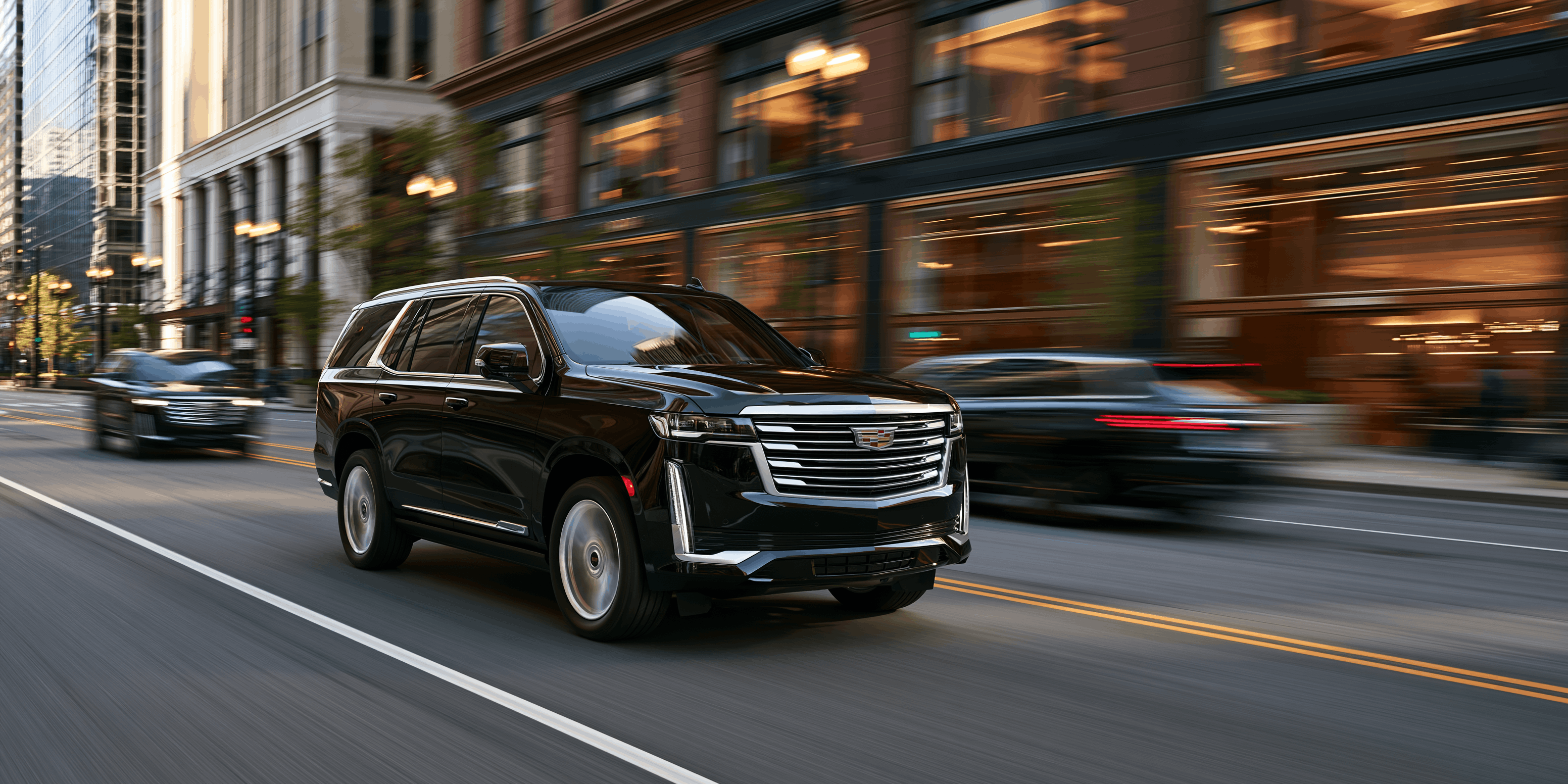 A black SUV driving down a city street